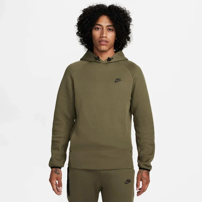 Model wearing the Tech Fleece Men’s Pullover Hoodie in dark olive — lightweight fleece hoodie designed for warmth, mobility, and modern street style.
