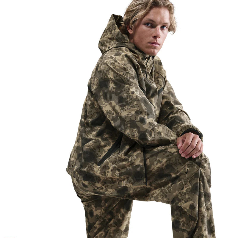 Tech Dri-FIT Woven Camo Windrunner Jacket with full-zip closure, hood, articulated elbows, and secure zip pockets in all-over camo print.