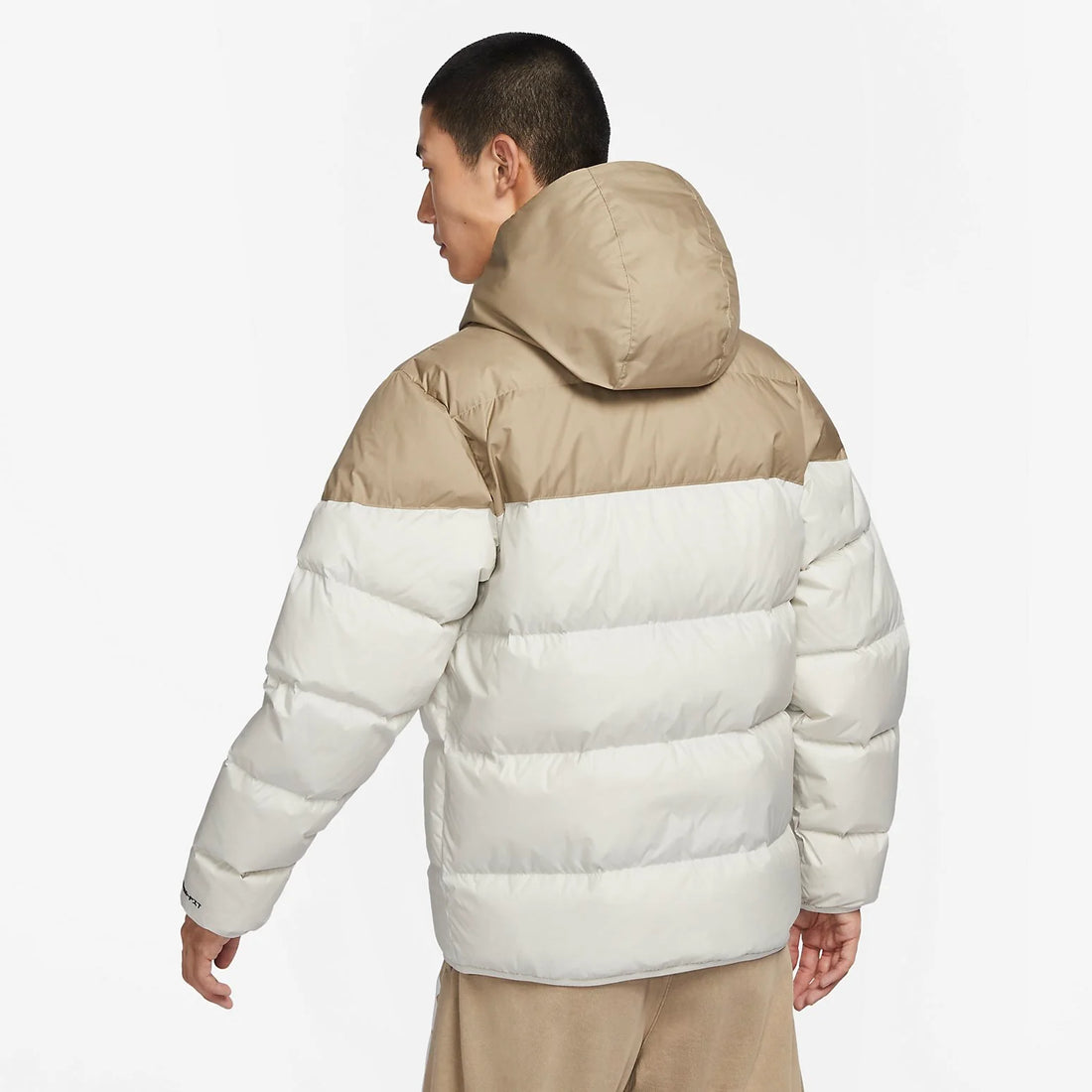 Model wearing Nike Windrunner PrimaLoft Storm-FIT Hooded Puffer Jacket in black – windproof woven shell, water-repellent finish and PrimaLoft ThermoPlume® insulation for cold weather.