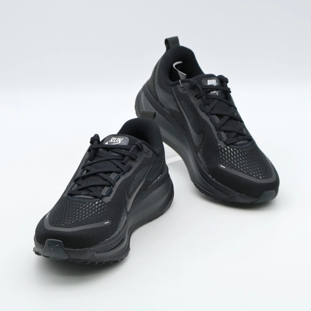 Air Zoom Vomero 18 Triple Black sneaker featuring breathable black mesh upper, cushioned sole with ZoomX and ReactX foam, and sleek all-black performance-inspired design.