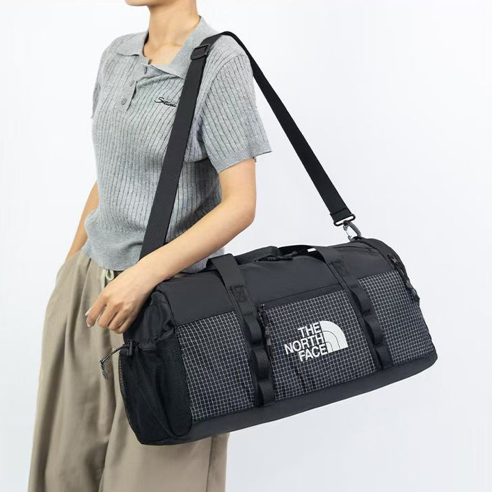 The North Face utility duffle bag in gray and black with structured design and dual carry handles