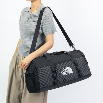 The North Face utility duffle bag in gray and black with structured design and dual carry handles