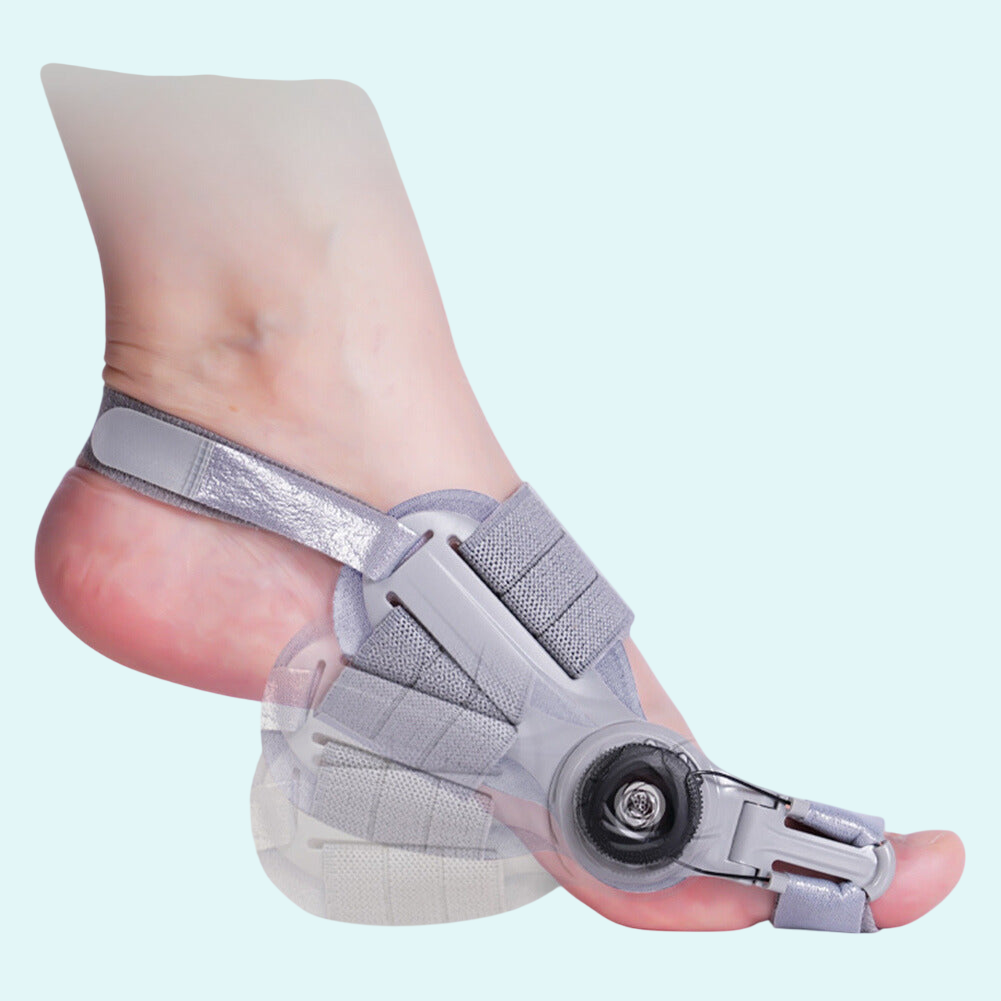 Adjustable bunion corrector brace worn on the left foot, made of soft gray fabric with Velcro straps for a secure and comfortable fit. Features a 180-degree movable hinge that gently realigns the big toe over time. The open design allows breathability and natural foot movement. Suitable for nighttime or daily wear during bunion correction therapy. Helps relieve pain, reduce pressure, and support proper toe alignment.