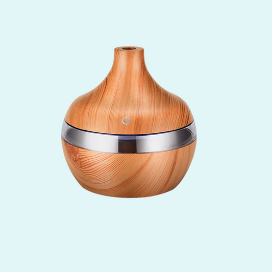 This elegant essential oil diffuser features a natural wood finish with a sleek silver accent, perfect for creating a calming ambiance. Ideal for use with your favorite essential oils, it disperses a fine mist into the air, promoting relaxation and wellness. Perfect for any room, its stylish design complements your home decor while improving air quality and adding a soothing fragrance.