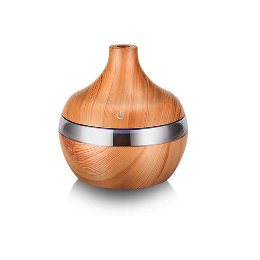 This elegant essential oil diffuser features a natural wood finish with a sleek silver accent, perfect for creating a calming ambiance. Ideal for use with your favorite essential oils, it disperses a fine mist into the air, promoting relaxation and wellness. Perfect for any room, its stylish design complements your home decor while improving air quality and adding a soothing fragrance.
