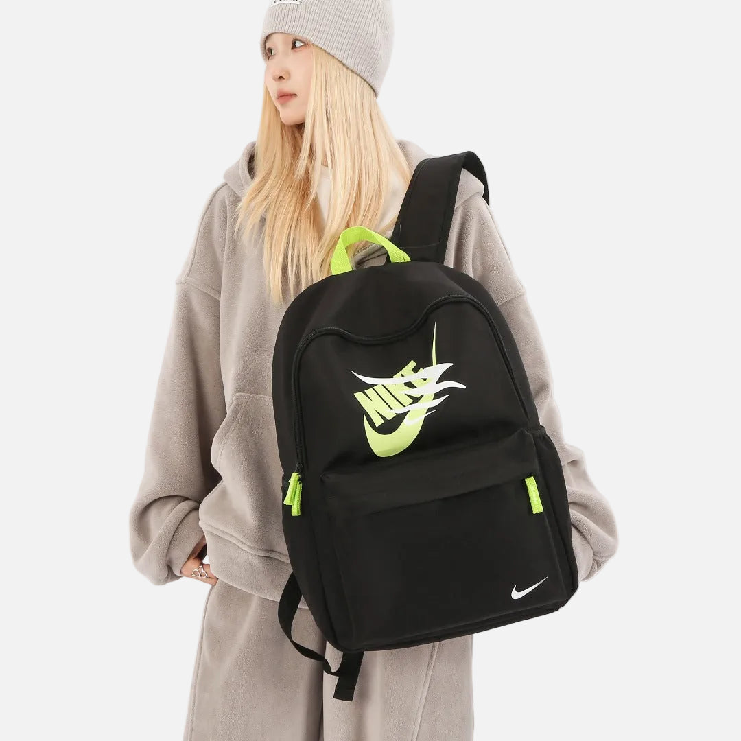 Nike Futura Carrying Case Backpack displayed in multiple colors, featuring spacious main compartment and front zip pocket.