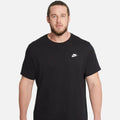 Man wearing Nike Sportswear Club T-Shirt in black/white — 100% cotton crew-neck with embroidered Futura logo on chest, relaxed fit for everyday wear.