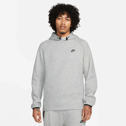 Model wearing the Tech Fleece Men’s Pullover Hoodie in grey — breathable fleece fabric with a clean, minimalist look and signature pullover design.