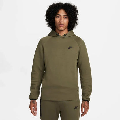Model wearing the Tech Fleece Men’s Pullover Hoodie in dark olive — lightweight fleece hoodie designed for warmth, mobility, and modern street style.