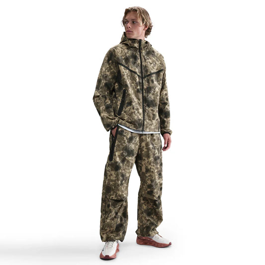 Tech Dri-FIT Woven Camo Windrunner Jacket and Loose-Fit Pants set in full camo print, oversized design blending performance and streetwear style.