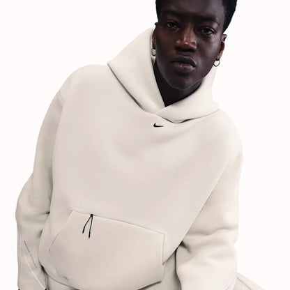 Nike Tech Fleece Oversized Hoodie in light bone white, featuring relaxed fit, front pouch pocket, and minimalist streetwear design.