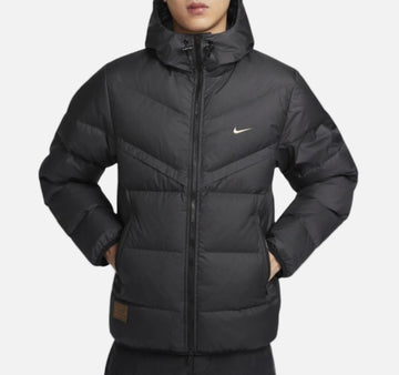 Man wearing Nike Windrunner Storm-FIT Jacket in black – hooded full-zip jacket with wind- and water-resistant shell and sleek urban design.