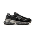 9060 Black Castlerock sneaker featuring breathable mesh upper in black and grey tones, suede overlays, chunky cushioned sole, and modern Y2K-inspired design. 