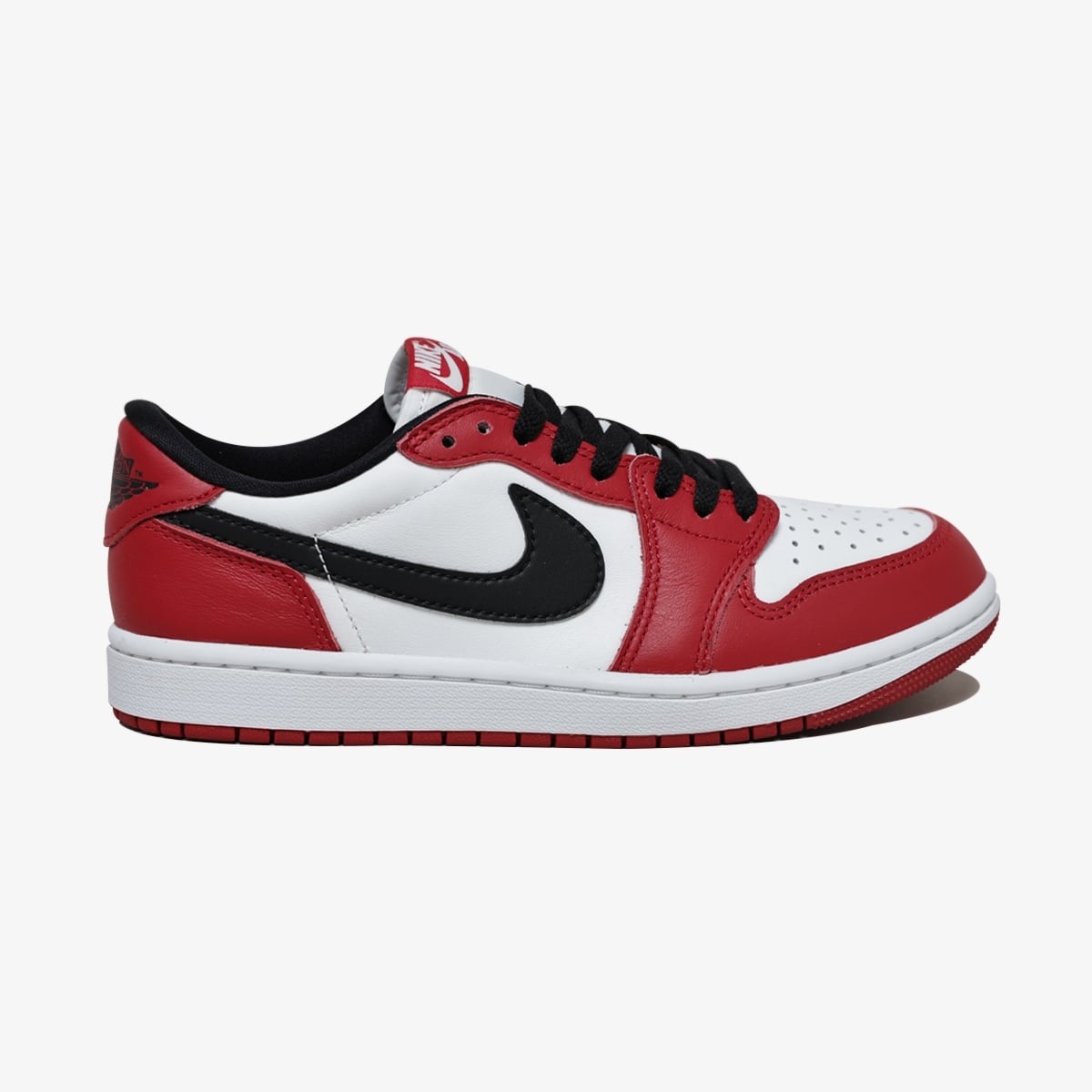 Air J. 1 Low High Retro Red White sneaker featuring white leather base, red overlays, black side detail, low-cut silhouette, and classic basketball-inspired design.