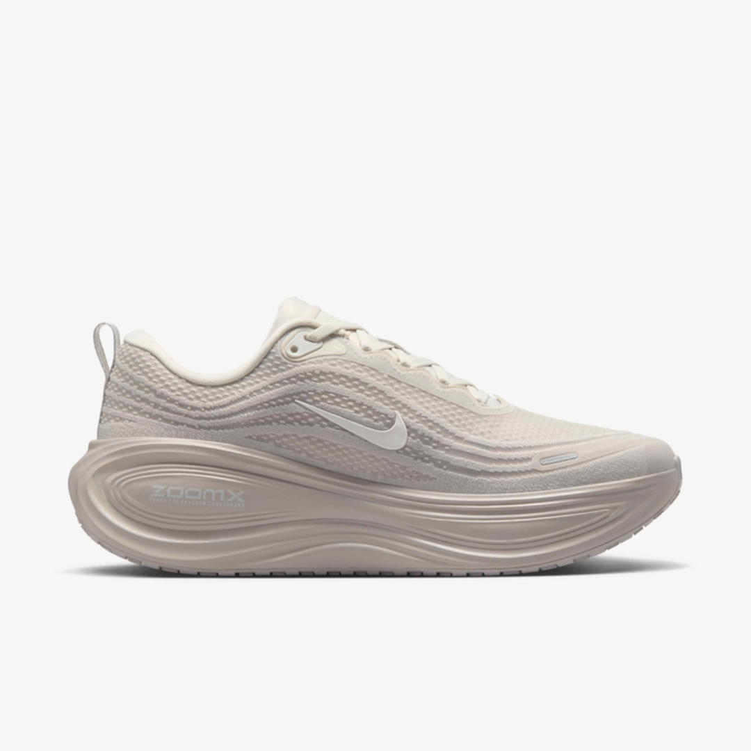 Air Zoom Vomero Plus Light Bone sneaker featuring breathable mesh upper in light beige tones, ZoomX and ReactX cushioning, and modern running-inspired design for everyday comfort.
