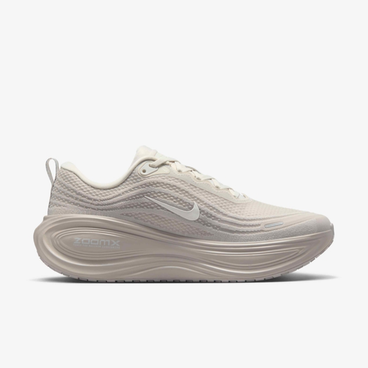 Air Zoom Vomero Plus Light Bone sneaker featuring breathable mesh upper in light beige tones, ZoomX and ReactX cushioning, and modern running-inspired design for everyday comfort.