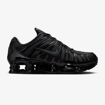 Nike Shox TL Triple Black sneaker featuring full-length Shox cushioning columns, breathable black mesh upper, molded overlays, and sleek monochrome athletic design.