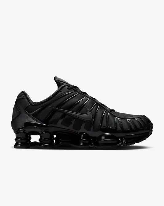 Nike Shox TL Triple Black sneaker featuring full-length Shox cushioning columns, breathable black mesh upper, molded overlays, and sleek monochrome athletic design.